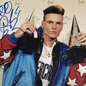 Vanilla Ice holding AMA awards, autographed in bold blue marker